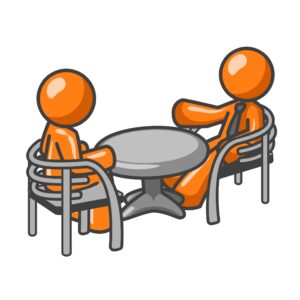 two people talking at a table