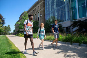 students walking in front of PSB in the summer